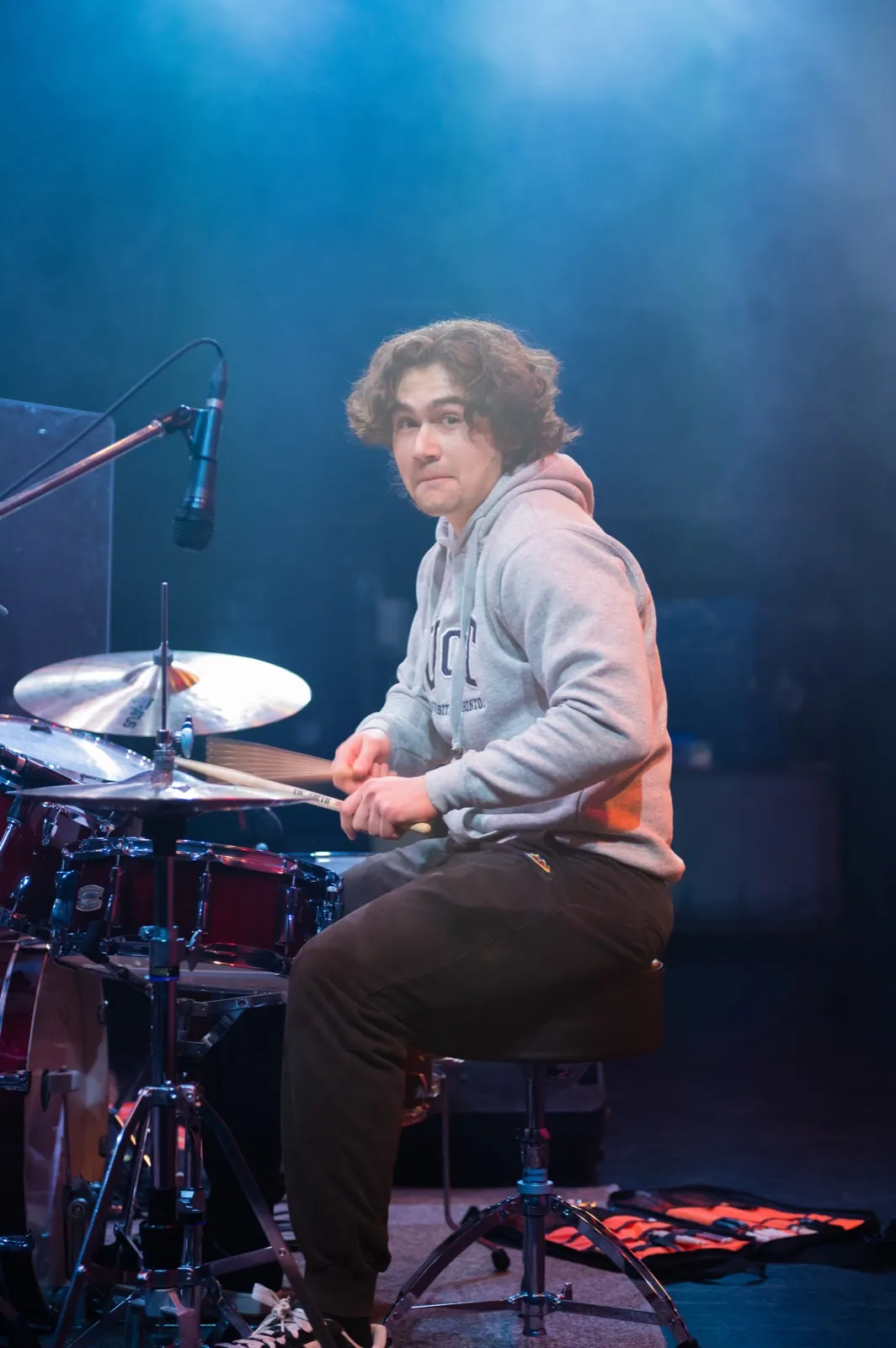 Daniel playing drums on stage.
